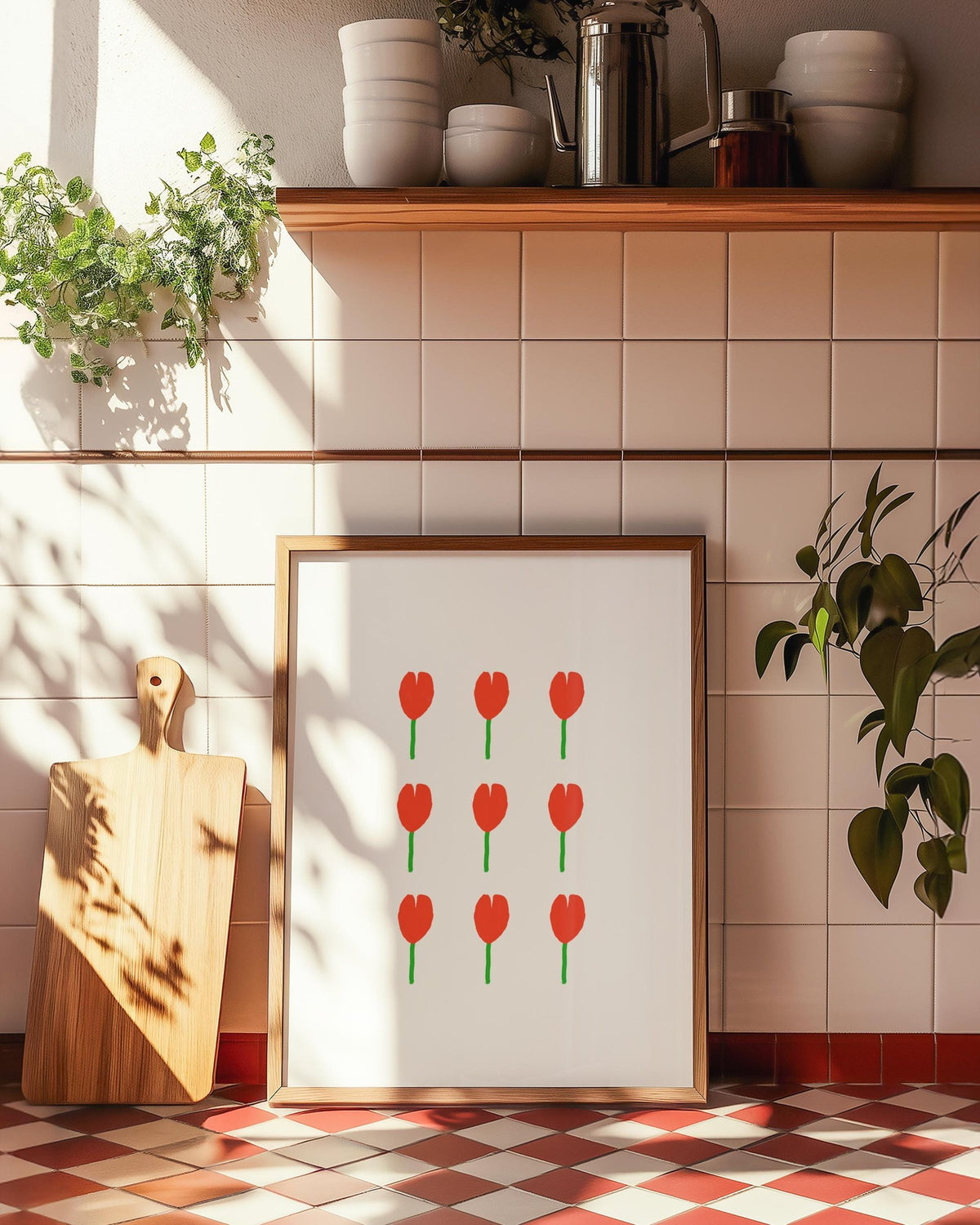 Kitchen corner with cream and red tiles, a chopping board, plants and a framed tulip print